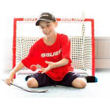 picture of a boy on his knees in front of a mini goal