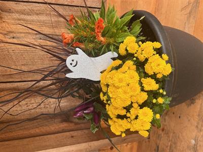 picture of container with yellow flowers and a ghost pick