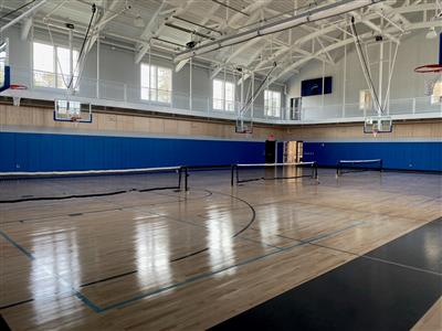 indoor pickleball nets set up with a view of whole gym