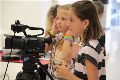 picture of two girls filming something with a studio camera